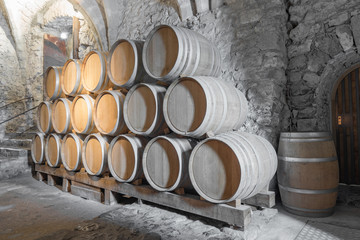 Ornate wine barrels in a cool castle cellar