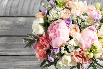 luxurious and elegant bouquet of roses and Other flowers. Composition colors on gray background. Copy space.