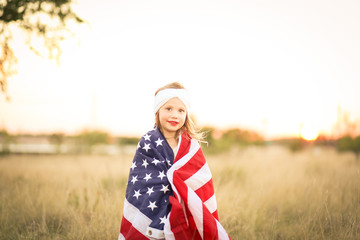 Adorable patriotic girl with american flag