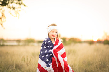 Adorable patriotic girl with american flag
