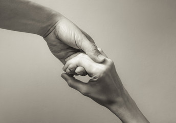 People helping each other concept. Closeup of hand helping another hand. 