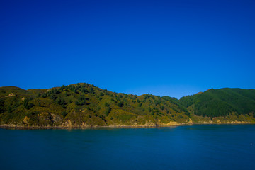 Fototapeta na wymiar Beautiful landscape of mountain with gorgeous blue sky in a sunny day seen from ferry from north island to south island, in New Zealand