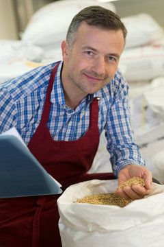 man posing in the grains stockroom