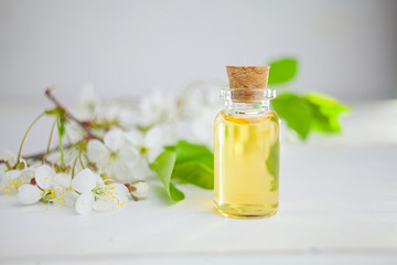 Essence of flowers on table in beautiful glass jar