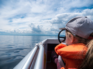 Girl steering a pedal boat on Lake Constance