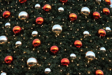 chritmas tree  background with baubles and lights in red gold colours 