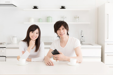 young asian couple relaxing in kitchen