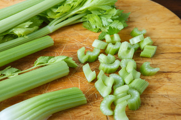 Celery chopped on wooden cutting board