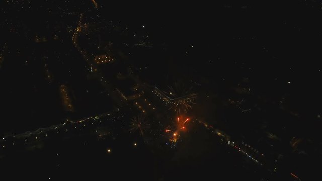 Aerial view Beautiful fireworks video from the drone in the night sky on celebration. Sparks. Fireworks are a class of explosive pyrotechnic devices used for aesthetic and entertainment purposes