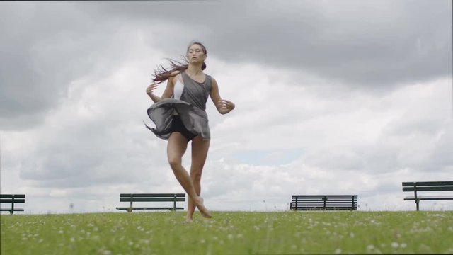 Attractive female dancer dances outdoors, in slow motion 