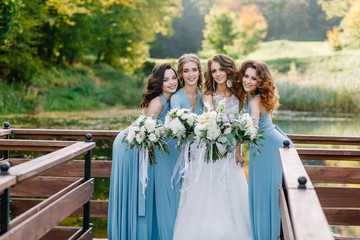 Stylish bridesmaids with the bride having fun on nature dnym. Trendy wedding, same bridesmaids...