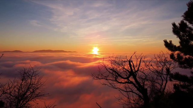 Time lapse movie of sunset with rolling fog, UHD