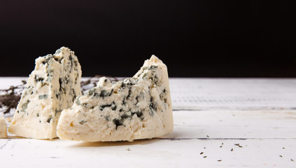 Soft blue cheese with pear on wooden background. Copy space for text