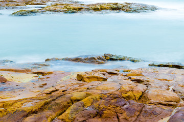 Fototapeta na wymiar Colourful rocks and water at Diamond Head coast, Australia