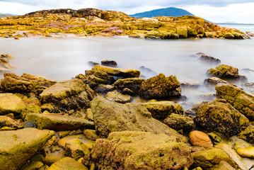 Colourful rocks and water at Diamond Head coast, Australia