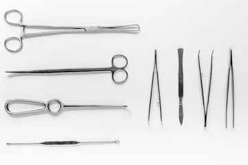 Medical instruments for plastic surgery on white backgrond top view