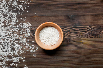paella ingredients with rice, salt, spices and tomatoes on wooden table background top view mock up