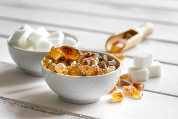 cooking sweets set with different sugar lumps on white table background close up