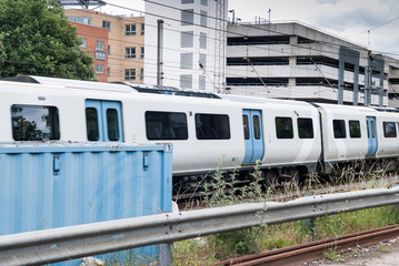 Fototapeta na wymiar Train on a railway line through a city background