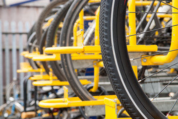bikes lined up in the store in yellow rack