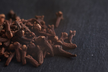 Macro photo of cloves spices on dark background.     Can be used for food blogs, food prints or designs and etc.