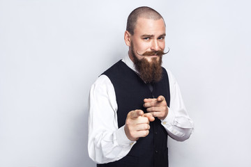 Hey you. Handsome businessman with beard and handlebar mustache looking at camera. studio shot, on...