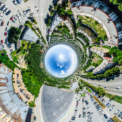 Aerial city view with crossroads and roads, houses, buildings, parks and parking lots, bridges. Helicopter drone shot. Wide Panoramic image.