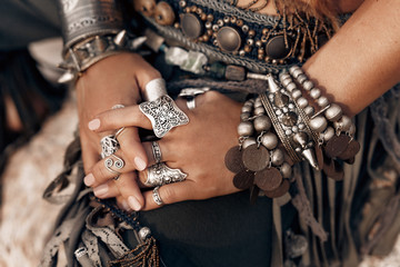 close up of woman hands with stylish tribal accessories