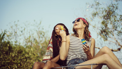 Hipster People Sitting on The Roof of The Van Road Trip Travel