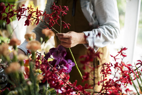 Flowerist working in the flower shop vintage style