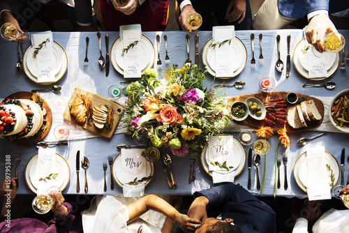 Groom kissing bride hand in wedding reception aerial view