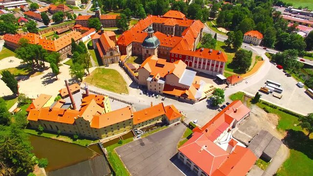 Camera flight over Cistercian monastery Plasy in Bohemia founded by a ruler – the prince Vladislav II. in 1144. European monuments from above. Czech Republic, Central Europe.