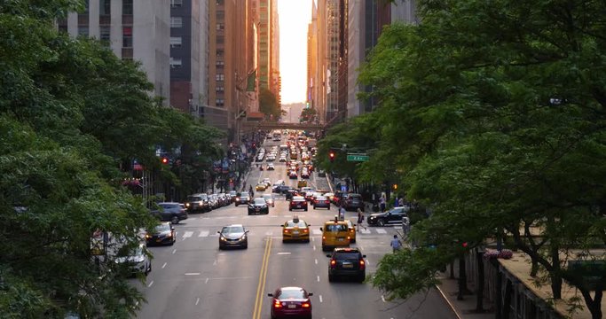 A slow motion evening establishing shot looking down 42nd Street in midtown Manhattan at sunset. Shot at 48fps.

