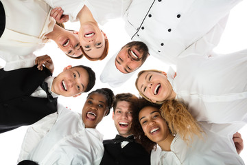 Smiling Restaurant Staff Standing Against White Background