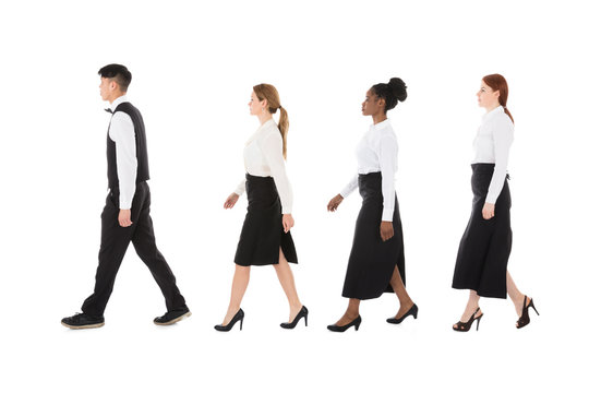Young Restaurant Staff Walking In Row