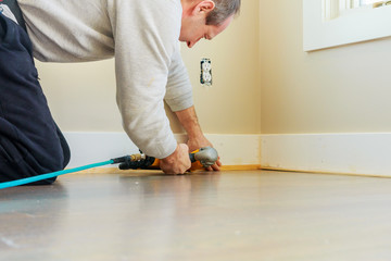 Gauge Finish Nailer man nailed slats custom house building contractor up a wall section for luxury