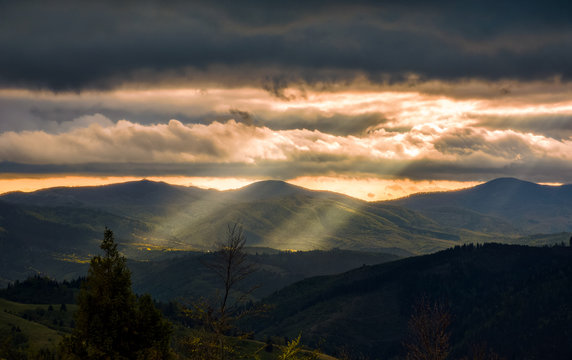 Carpathian valley at cloudy sunset