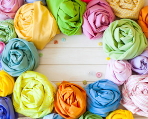 Accessories for sewing lie on a white background. Measuring tape, thread, fabric and needles for sewing. Color fabric.