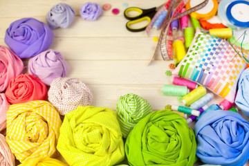 Accessories for sewing lie on a white background. Measuring tape, thread, fabric, needle bar and...