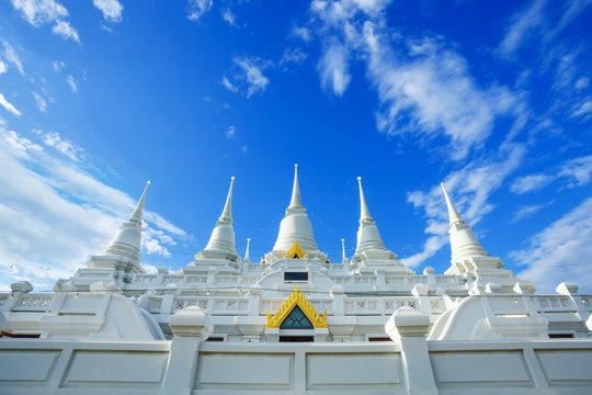 A large, elaborate white Buddhist Pagoda with multiple spires at Wat Asokara Temple in Thailand