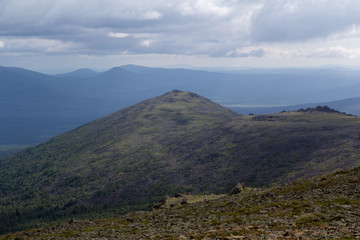 Panoramic view of the mountains and cliffs, South Ural. Summer in the mountains. Travel. Cloudy sky over the mountains.