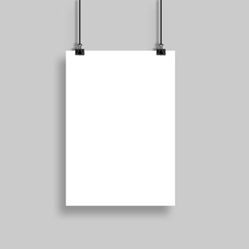 White poster hanging with binder clip on grey wall background for mock up and design template.