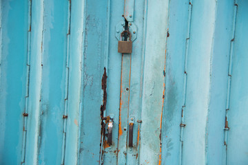 Mettalic lock without the key on the blue vintage door,Residential mettalic folding door with blue locking device installed