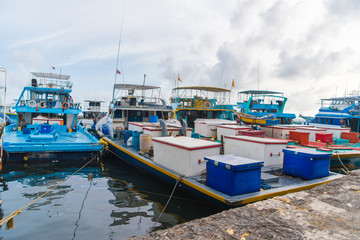 Fototapeta na wymiar Fishing boats in the harbor in city Male, capital of Maldives