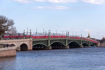 Fototapeta premium Row of festive flags with a St. George ribbon on Trinity bridge, set in honor of the Victory Day Victory on May 9