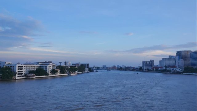 Bangkok city at sunset with lighted boats on the river, time lapse, 4K