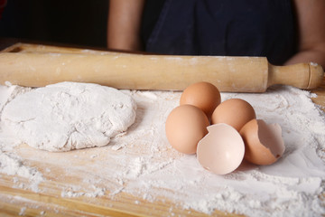 A dough, eggs and rolling pin.
