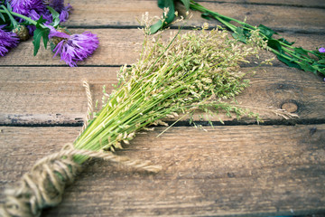 Sheaf of hay on a wooden background.