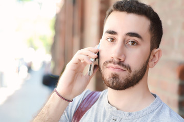 Latin man talking on the phone