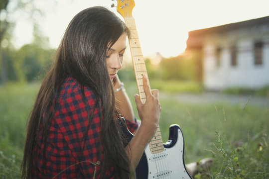 Girl with electric guitar.